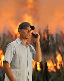 Man using mobile phone during fire emergency